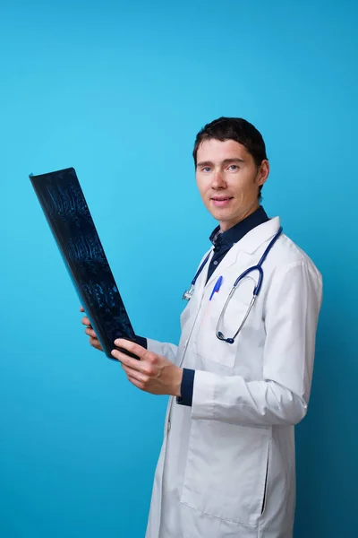 Portrait of a doctor with a stethoscope on the neck and an X-ray in hand — Stock Photo, Image