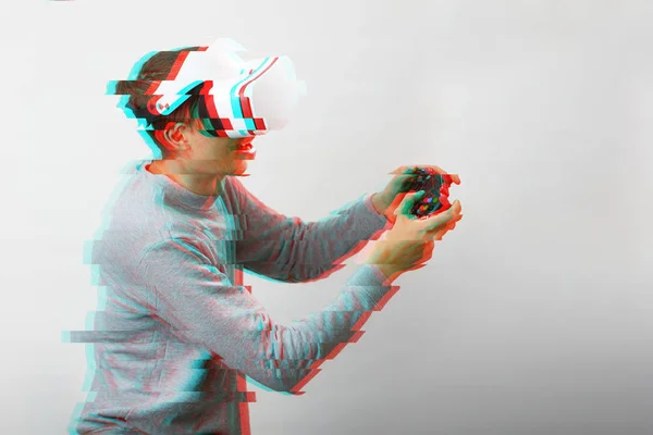 Uomo con auricolare realtà virtuale sta giocando. Immagine con effetto glitch. — Foto Stock