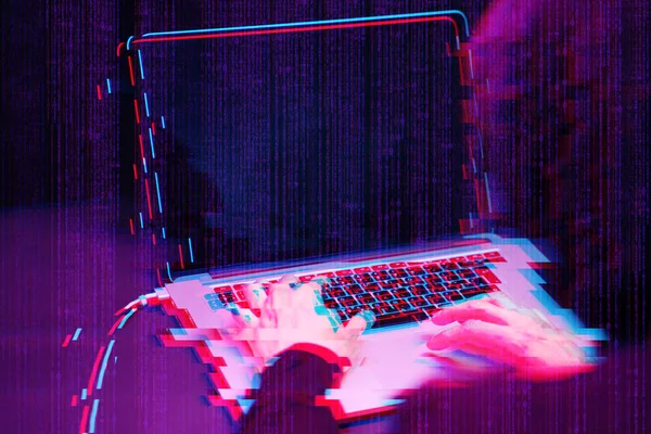 Hacker working with laptop in dark room with digital interface around. Image with glitch effect. — Stock Photo, Image