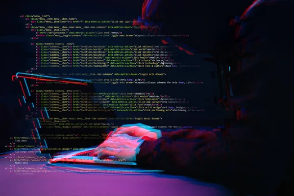 Hacker working with laptop in dark room with digital interface around. Image with glitch effect. — Stock Photo, Image