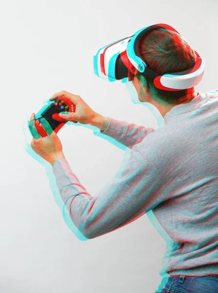 Man with virtual reality headset is playing game. Image with glitch effect. — Stock Photo, Image