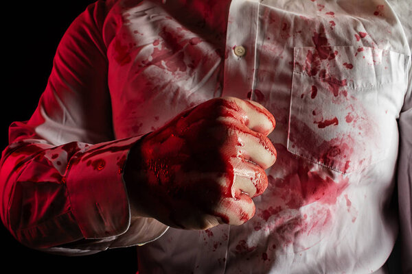 Murderer man bloody fist in white bloody shirt.