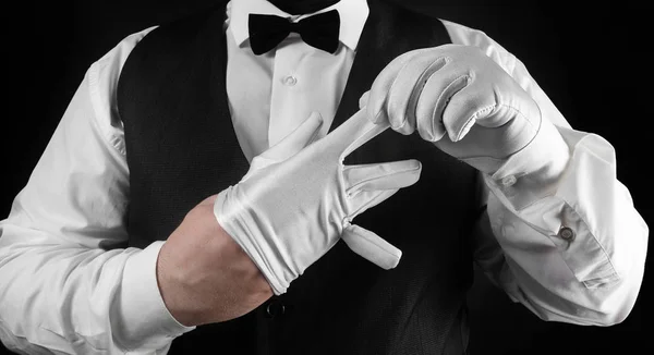 Waiter putting off white glove.