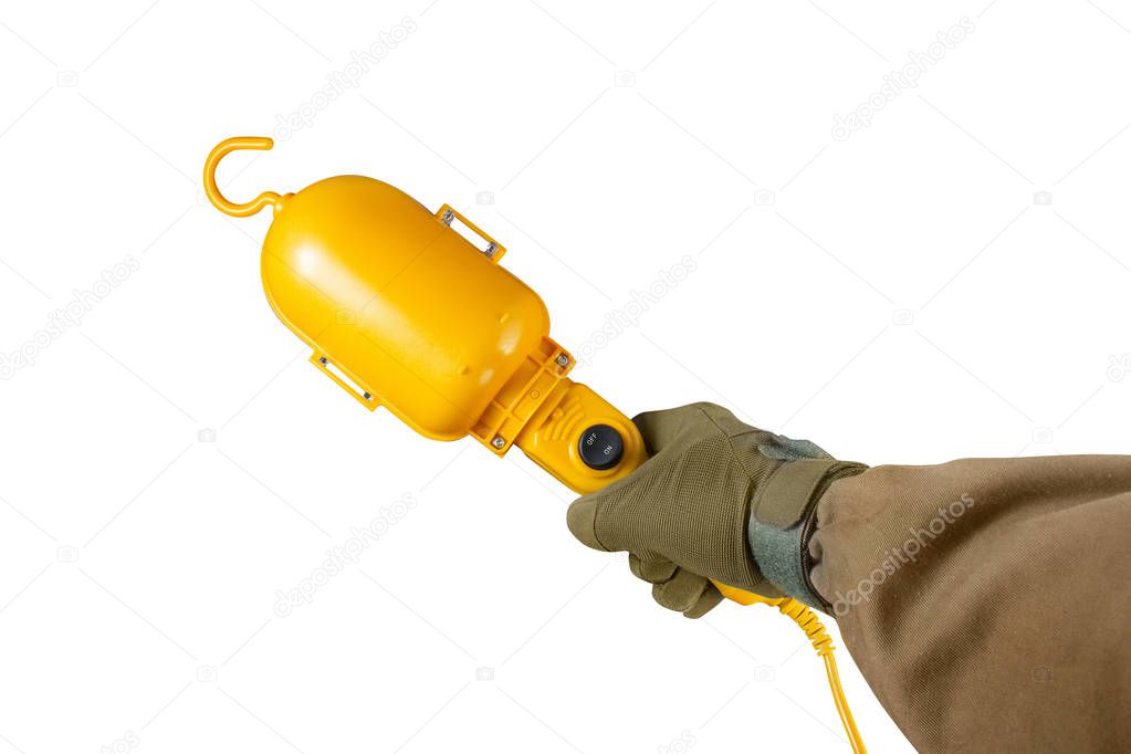 Arm holding yellow portable lamp.