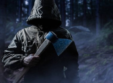 Scary killer with an axe in woods. clipart