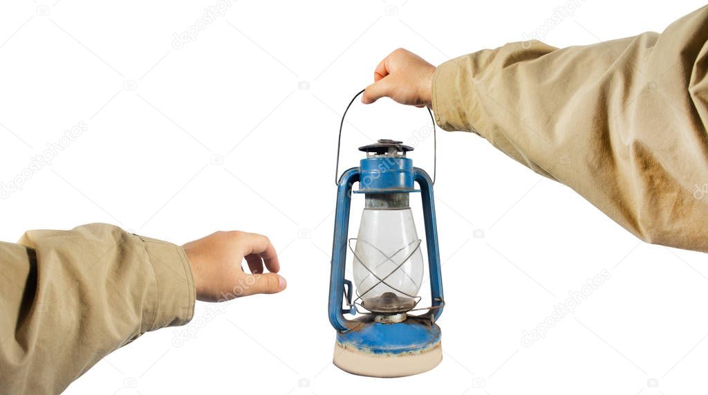 Male hands in jacket holding old-fashioned lantern.
