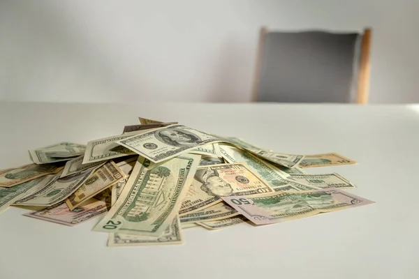 pile of dollar with chair on background. cash money . Business bribery , kickback, corruption and venality concepts.