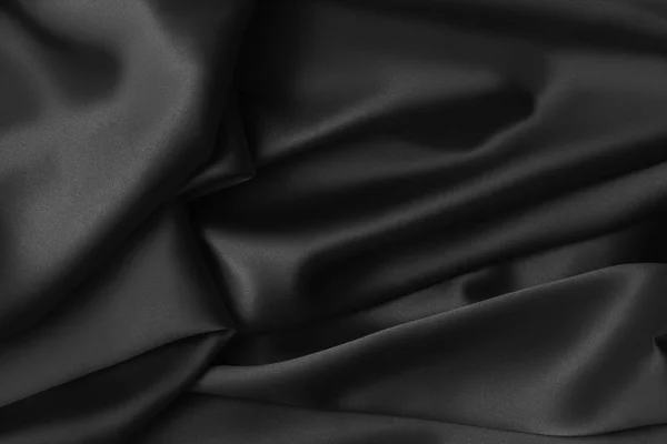 Schwarzer luxuriöser welliger, glänzender Seidenstoff — Stockfoto