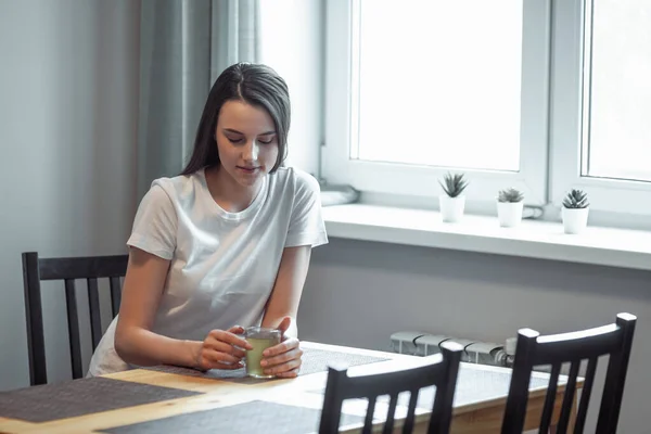 stock image beautiful young woman drinking hot beverage. Attractive girl relaxing at home