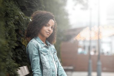 Çekici esmer kız portresi. Şehirli hippi genç kadın sokakta yürüyor.