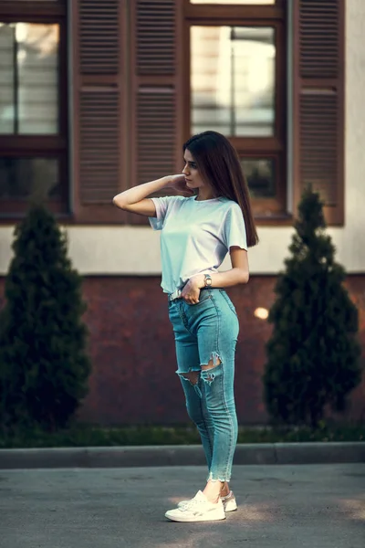 Hipster girl casual wear. Summer city portrait. Young tourist woman walks in town