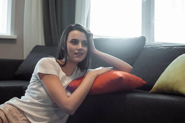 Young woman pretty relaxing on couch in living room. Casual style indoor shoot