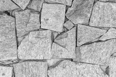 Gray stone wall texture with interlocking irregular shapes.