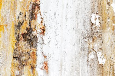 Textured rustic wall with peeling paint and weathered surfaces.