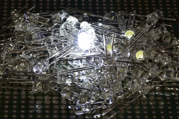 Low-power semiconductor white LEDs in transparent plastic housing. Demonstration of the classic indicator for electronic systems.