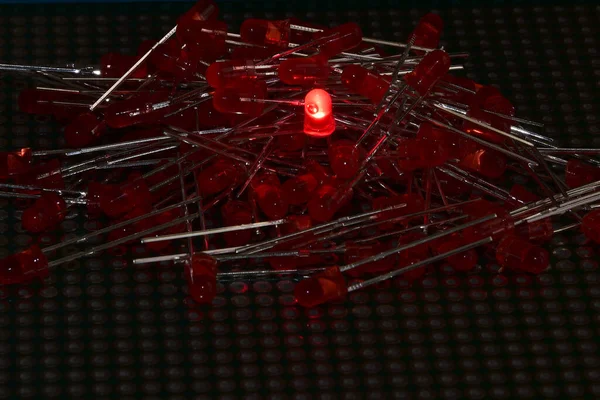 Low-power semiconductor red LEDs in a semitransparent plastic case. Demonstration of the classic indicator for electronic systems.