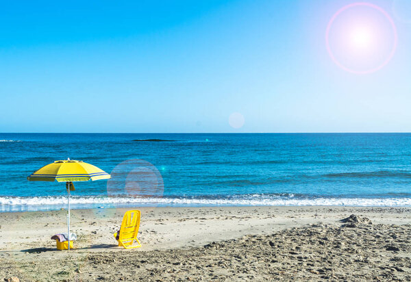 yellow beach umbrella on the sea