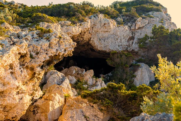cave of broken vessels, in the sardinian coast, at sunset