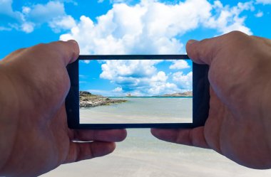 Sahilde akıllı telefonla el fotoğrafı çekme