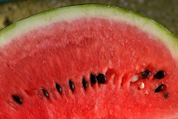 sliced red watermelon with black seeds.