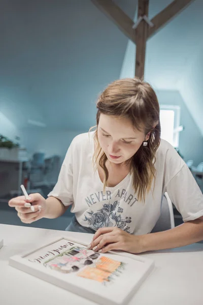 happy and beatifull female artist drawing the picture at her studio