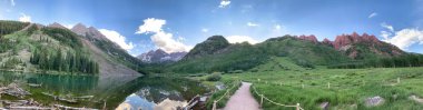 Panoramic picture of the paths and cliffs surrounding maroon bells in the colorado rocky mountains. State park with beautiful scenery and natural landscapes clipart