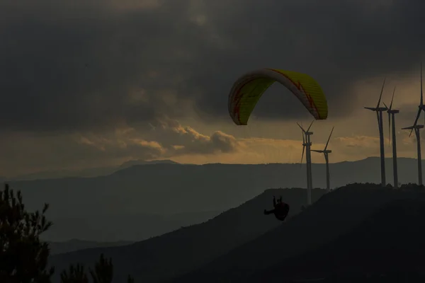 Paragliding between wind turbines in Anoia, Barcelona, Spain