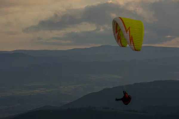 Paragliding between wind turbines in Anoia, Barcelona, Spain