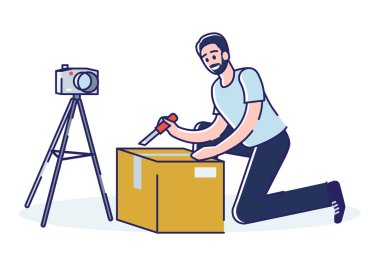 Adam vlogger blog kanalı için paket açma videosu oluşturuyor. Kutuları açan adam satın alıyor ve gözden geçiriyor