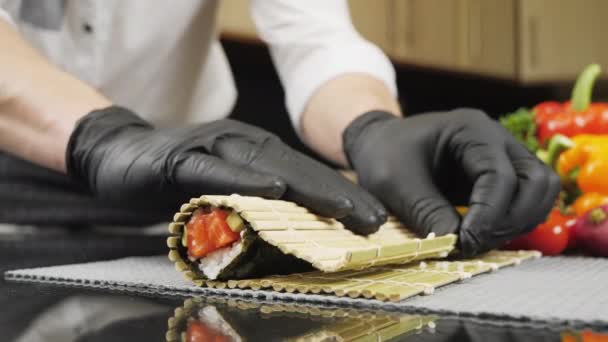 Vařit ruce dělat japonské sushi roll s bambusovou rohožkou. — Stock video