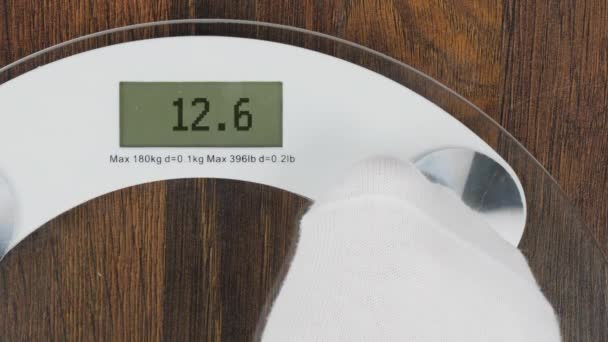 Inscription OVERWEIGHT on bathroom scales digital display — Stock video