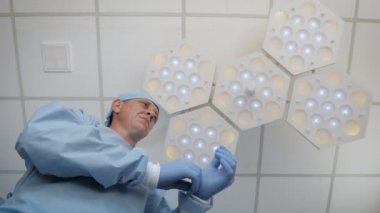 Doktor ameliyathanede steril lateks eldiven giyiyor.