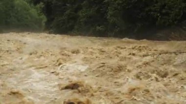 Doğal afetler ve aşırı hava. Kirli suyla azgın bir nehir