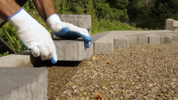Builder laying pavement rocks on the street. — Stock Footage Builder laying pavement rocks on the street. Video Clip