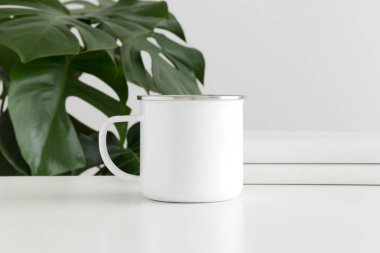 Enamel 'in çalışma alanı aksesuarları ve bir canavar bitkisi olan kupası..