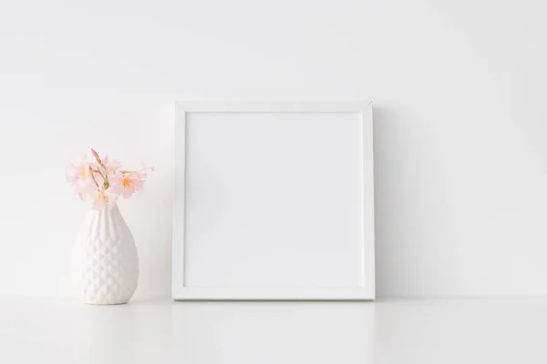 White square frame mockup with pink oleander in a vase.