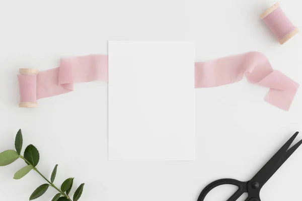 Download Top View Of A White Card Mockup With Silk Ribbons Scissors And Green Branch On A White Table Birthday Notecard Stock Photo 394301352