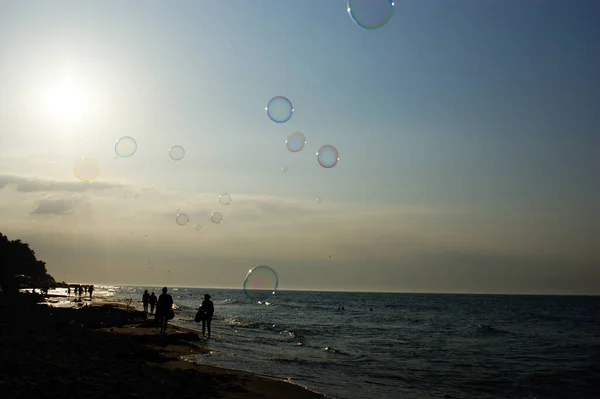 soap bubbles in the wind on the seashore on the sea