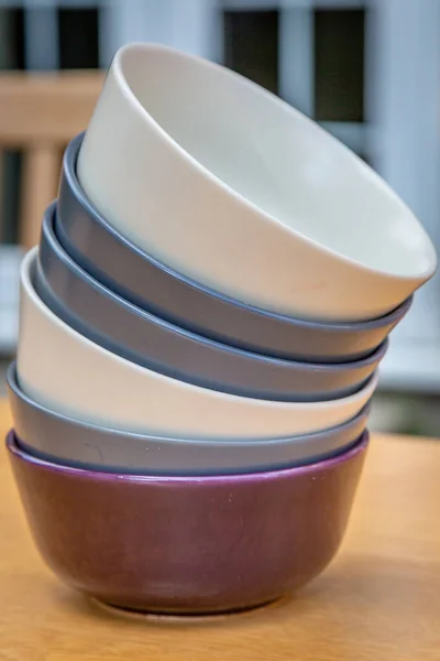 Bowls stacked on an outdoor table, with a shallow depth of field