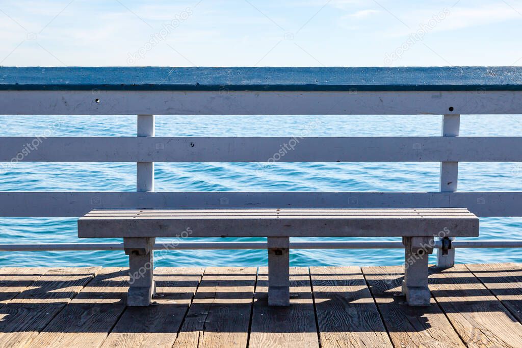 A bench on San Clemente Pier in California, overlooking the ocean