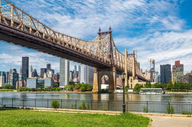 A view of Queensboro bridge and the Manhattan Skyline, from Queensbridge Park, Long Island clipart