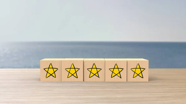 Wooden Cartoon Cube Five Yellow Star Review Blur Sea Sky — стоковое фото