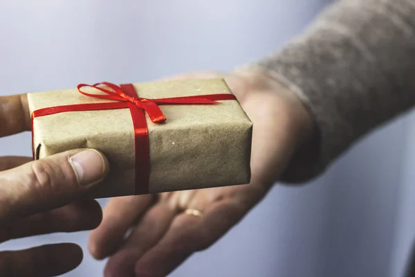 Man Gives Woman Gift Red Ribbon Stock Image