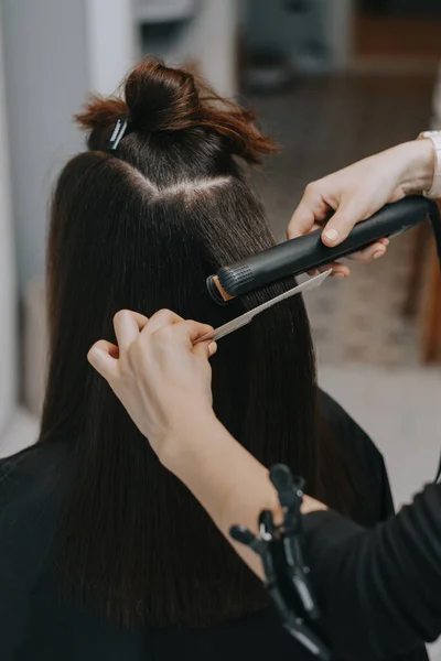 Womens haircut at home. Hairdresser cuts a girl at home.