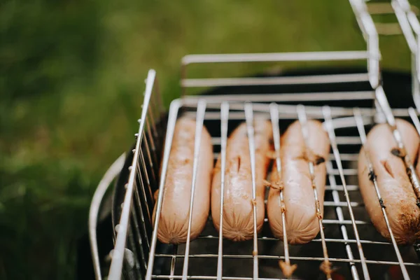 Salsicce di carne alla griglia su una griglia. Picnic all'aria aperta — Foto Stock