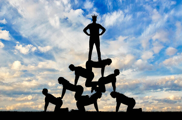 Silhouette narcissistic egoist man wearing a crown standing on humans