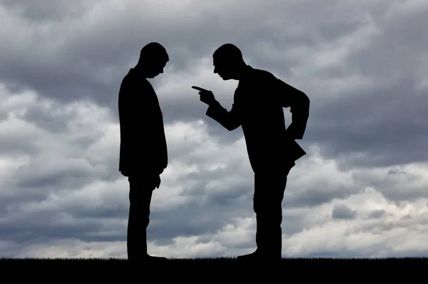Silhouette of a boss yelling at a man employee with his head bowed — Stock Photo, Image
