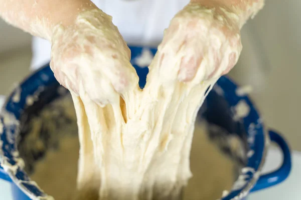 the hands of a small child play with the dough in a large pan. activities with children