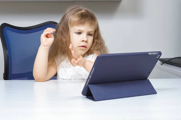 little girl doing mental arithmetic online.the child trains memory with the fingers