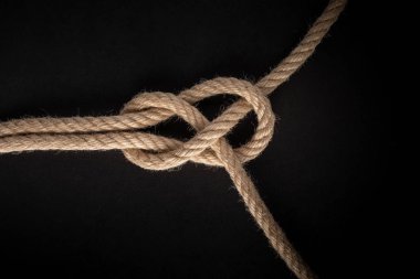 Sheet Band Knot on black background. Rope node.